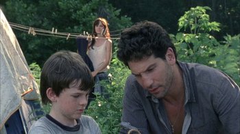Movie still from “The Walking Dead” (2010), directed by Daniel Sackheim – A man and a woman standing next to each other; Medium shot, Over the shoulder angle