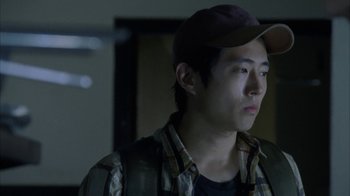 Movie still from “The Walking Dead” (2010), directed by Daniel Sackheim – A man wearing a hat and a plaid shirt; Close Up shot, Over the shoulder angle