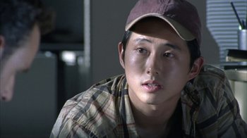 Movie still from “The Walking Dead” (2010), directed by Daniel Sackheim – A young man wearing a hat and a plaid shirt; Close Up shot, High angle