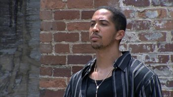Movie still from “The Walking Dead” (2010), directed by Daniel Sackheim – A man in a black and white striped shirt is looking to his left; Close Up shot, Low angle