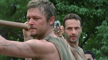 Movie still from “The Walking Dead” (2010), directed by Daniel Sackheim – Two men are holding guns and posing for a picture; Close Up shot, Low angle