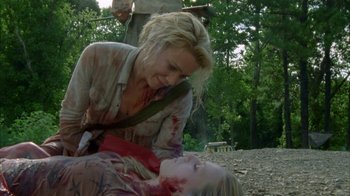Movie still from “The Walking Dead” (2010), directed by Daniel Sackheim – A woman is holding a knife over a woman's face; Medium shot, Over the shoulder angle