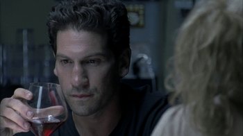 Movie still from “The Walking Dead” (2010), directed by Daniel Sackheim – A person holding a glass of wine; Close Up shot, Over the shoulder angle
