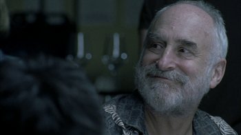 Movie still from “The Walking Dead” (2010), directed by Daniel Sackheim – An older man with a beard and a mustache; Close Up shot, Over the shoulder angle