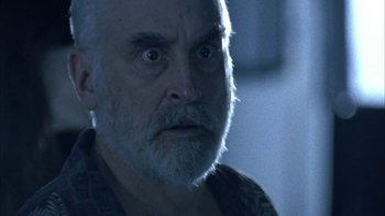 Movie still from “The Walking Dead” (2010), directed by Daniel Sackheim – An older man with a beard stares at the camera; Close Up shot, Low angle