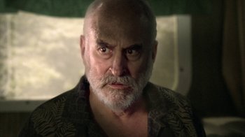 Movie still from “The Walking Dead” (2010), directed by Daniel Sackheim – An old man with a beard and a mustache; Close Up shot, Over the shoulder angle