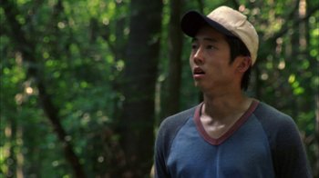 Movie still from “The Walking Dead” (2010), directed by Daniel Sackheim – A man in a baseball cap standing in the woods; Close Up shot, Low angle