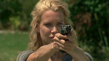 Movie still from “The Walking Dead” (2010), directed by Daniel Sackheim – A woman holding a gun in her hands; Close Up shot, Low angle