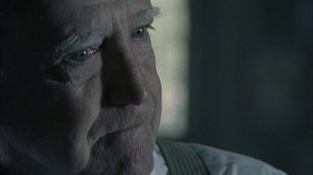 Movie still from “The Walking Dead” (2010), directed by Daniel Sackheim – An older man with a serious look on his face; Close Up shot, Over the shoulder angle