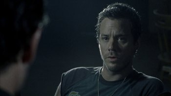 Movie still from “The Walking Dead” (2010), directed by Daniel Sackheim – A person wearing a necklace; Close Up shot, Over the shoulder angle
