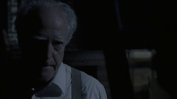 Movie still from “The Walking Dead” (2010), directed by Daniel Sackheim – An older man wearing a white shirt and a tie; Close Up shot, Over the shoulder angle