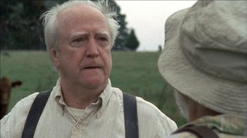 Movie still from “The Walking Dead” (2010), directed by Daniel Sackheim – An older man in a white shirt is talking to an older woman in a white hat; Close Up shot, Over the shoulder angle