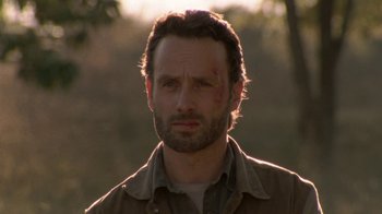 Movie still from “The Walking Dead” (2010), directed by Daniel Sackheim – A person wearing a shirt; Close Up shot, Over the shoulder angle