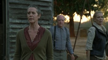 Movie still from “The Walking Dead” (2010), directed by Daniel Sackheim – An older man and a younger woman standing next to each other; Medium shot, Low angle