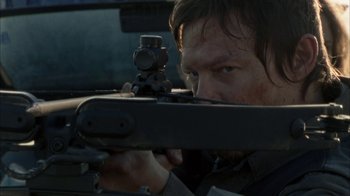 Movie still from “The Walking Dead” (2010), directed by Daniel Sackheim – A man with a rifle aiming at something in the distance; Close Up shot, Low angle
