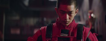 Movie still from “The Wandering Earth” (2019), directed by Frant Gwo – A man in a red jacket is looking down; Close Up shot, Low angle