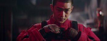 Movie still from “The Wandering Earth” (2019), directed by Frant Gwo – A man in a red jacket is holding a pair of gloves; Close Up shot, Low angle