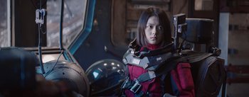 Movie still from “The Wandering Earth” (2019), directed by Frant Gwo – A woman in a red jacket sitting in a chair; Medium shot, Low angle