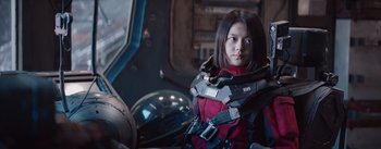 Movie still from “The Wandering Earth” (2019), directed by Frant Gwo – A woman in a red jacket is sitting in a chair; Medium shot, Low angle