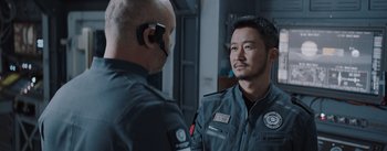 Movie still from “The Wandering Earth” (2019), directed by Frant Gwo – A man in a uniform talking to another man in a uniform; Close Up shot, Over the shoulder angle