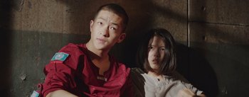 Movie still from “The Wandering Earth” (2019), directed by Frant Gwo – A man and a woman standing next to each other; Medium shot, Low angle