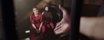 Movie still from “The Wandering Earth” (2019), directed by Frant Gwo – Two people sitting in a room next to each other; Medium shot, High angle