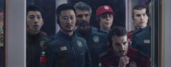 Movie still from “The Wandering Earth” (2019), directed by Frant Gwo – A group of men standing next to each other; Medium shot, Over the shoulder angle