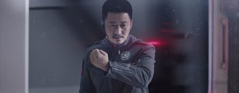 Movie still from “The Wandering Earth” (2019), directed by Frant Gwo – A man in a gray jacket is holding his fist; Close Up shot, Low angle