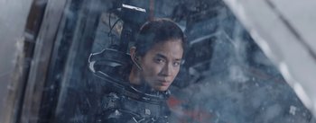 Movie still from “The Wandering Earth” (2019), directed by Frant Gwo – A woman with a headset on looking into the distance; Close Up shot, Low angle