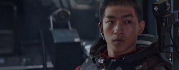 Movie still from “The Wandering Earth” (2019), directed by Frant Gwo – A young man in a red and black outfit; Close Up shot, Over the shoulder angle