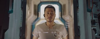 Movie still from “The Wandering Earth” (2019), directed by Frant Gwo – A man in a white shirt is in an elevator; Close Up shot, Overhead angle