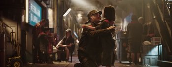 Movie still from “The Wandering Earth” (2019), directed by Frant Gwo – A man and a woman are hugging in the street; Wide shot, Over the shoulder angle