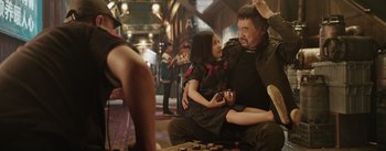 Movie still from “The Wandering Earth” (2019), directed by Frant Gwo – A man and a little girl sitting on the ground; Medium shot, Over the shoulder angle