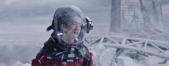 Movie still from “The Wandering Earth” (2019), directed by Frant Gwo – A man in a space suit with a helmet on; Medium shot, Over the shoulder angle