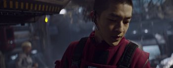 Movie still from “The Wandering Earth” (2019), directed by Frant Gwo – A man wearing a red shirt and a black jacket; Close Up shot, Low angle