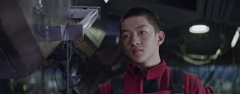 Movie still from “The Wandering Earth” (2019), directed by Frant Gwo – A man in a red jacket is looking at the camera; Close Up shot, Low angle