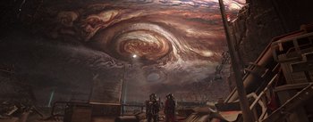 Movie still from “The Wandering Earth” (2019), directed by Frant Gwo – A group of people standing under a painting of the sky; Extreme Wide shot, Overhead angle