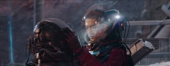 Movie still from “The Wandering Earth” (2019), directed by Frant Gwo – A man in a space suit looking at something in his hand; Medium shot, Low angle