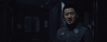 Movie still from “The Wandering Earth” (2019), directed by Frant Gwo – A man in a uniform standing in a dark room; Close Up shot, Over the shoulder angle