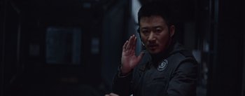 Movie still from “The Wandering Earth” (2019), directed by Frant Gwo – A man in a black jacket is holding his hand up; Close Up shot, Over the shoulder angle