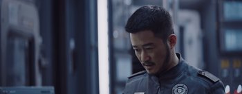 Movie still from “The Wandering Earth” (2019), directed by Frant Gwo – A person wearing a uniform; Close Up shot, Over the shoulder angle