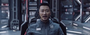 Movie still from “The Wandering Earth” (2019), directed by Frant Gwo – A man in a leather jacket is sitting in a chair; Close Up shot, Over the shoulder angle