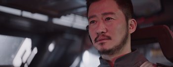 Movie still from “The Wandering Earth” (2019), directed by Frant Gwo – A person with a cell phone; Close Up shot, Over the shoulder angle