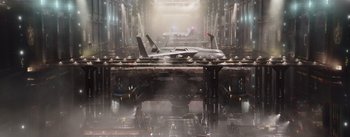 Movie still from “The Wandering Earth” (2019), directed by Frant Gwo – An airplane is shown on a platform in an industrial setting; Extreme Wide shot, Overhead angle