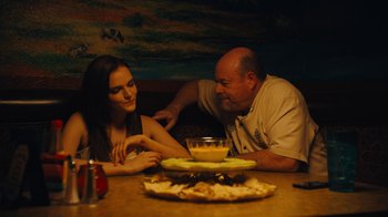 A man and a woman sitting at a dinner table