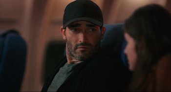 Movie still from “Can You Keep a Secret?” (2019), directed by Elise Durán – A person wearing a hat; Close Up shot, Over the shoulder angle