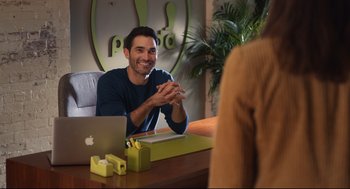 Movie still from “Can You Keep a Secret?” (2019), directed by Elise Durán – A man sitting in front of a woman at a table; Medium shot, Over the shoulder angle