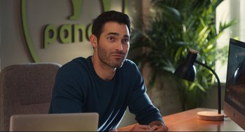 Movie still from “Can You Keep a Secret?” (2019), directed by Elise Durán – A man sitting in front of a laptop computer; Close Up shot, Over the shoulder angle