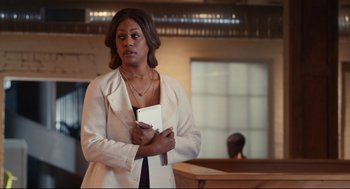 Movie still from “Can You Keep a Secret?” (2019), directed by Elise Durán – A woman in a white jacket is holding a tablet; Medium shot, Over the shoulder angle