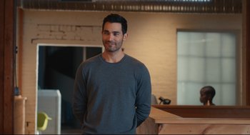Movie still from “Can You Keep a Secret?” (2019), directed by Elise Durán – A man standing in front of a counter; Medium shot, Over the shoulder angle